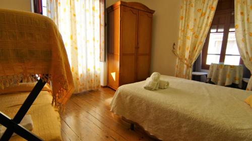 a bedroom with a bed and a dresser and a window at Pensión Sandoval by gaiarooms in León
