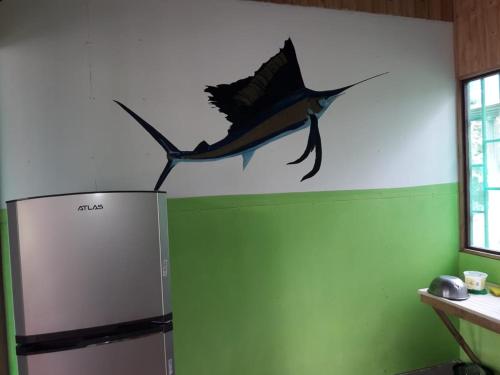 a fish on the wall of a room with a refrigerator at Hotel Jhazmin Aeropuerto in Drake