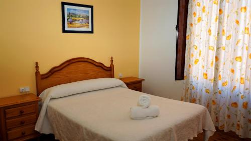 a bedroom with a bed with a white box on it at Pensión Sandoval by gaiarooms in León