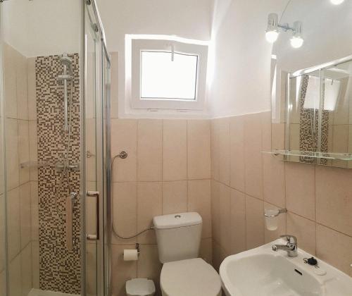 a bathroom with a toilet and a sink and a shower at Lagoas in Tavira