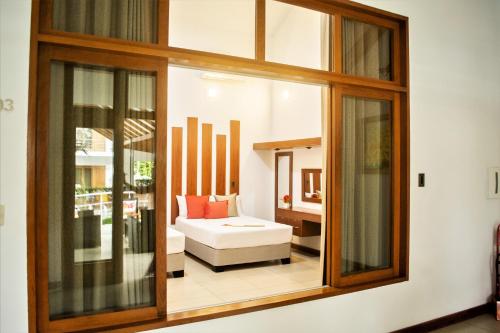a room with a window with a couch in it at Colina de Montalva in Tarapoto