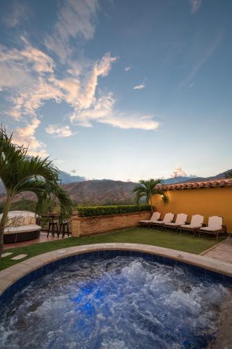 a swimming pool in the yard of a house at Nueva Granada Hotel Colonial -Centro Histórico- in Santa Fe de Antioquia