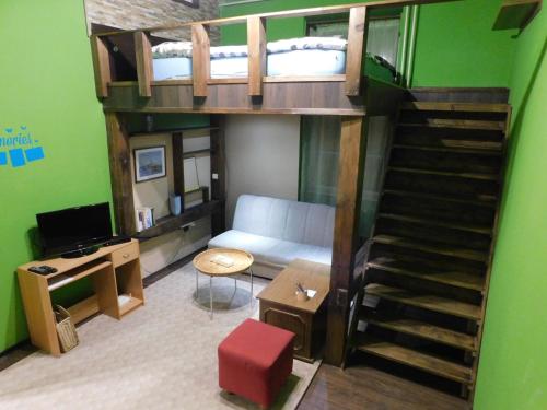 a small room with a bunk bed and a staircase at Körmend lakás in Körmend