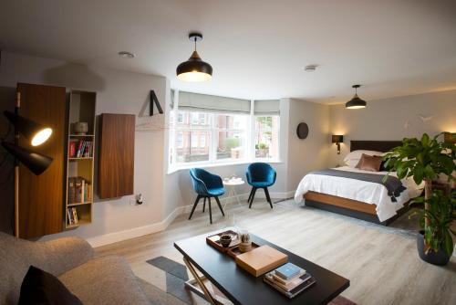 a bedroom with a bed and a living room at West House, 36A Whitstable Road in Canterbury