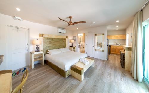 a bedroom with a large bed and a kitchen at Lime Tree Bay Resort in Islamorada