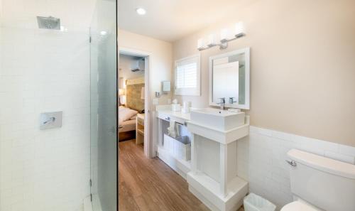 a white bathroom with a sink and a mirror at Lime Tree Bay Resort in Islamorada