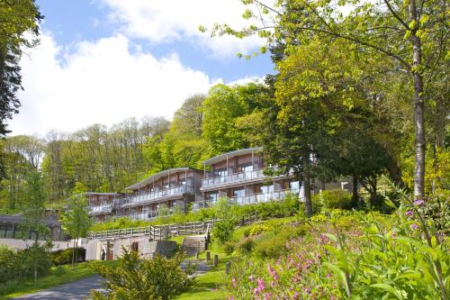 a hotel in the middle of a garden at The Cornwall Hotel Spa & Lodges in St Austell