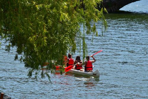 a group of people in a boat on the water at Casas de Pousadouro in Baião