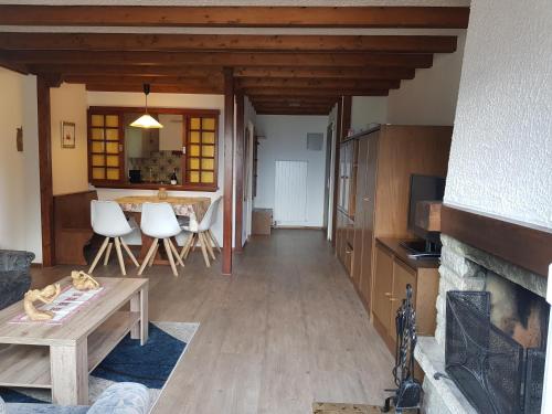 a living room with a table and a fireplace at Clabina 31 in Leukerbad