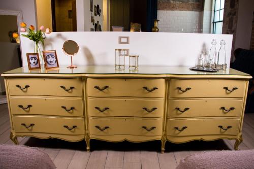a yellow dresser with a mirror on top of it at Luma B&B Boutique in Puebla