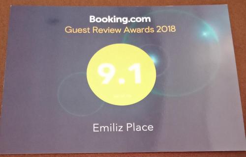 a sign for the guest review awards with a yellow circle at Emiliez Place in Baguio