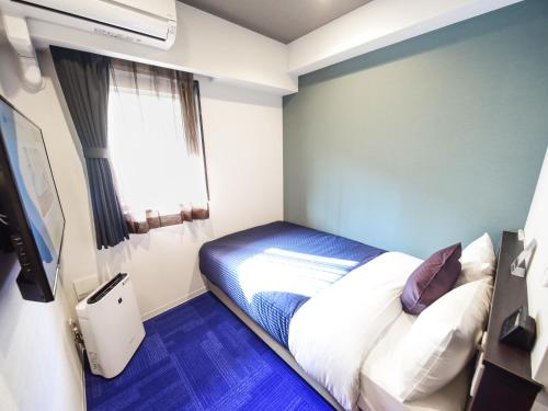 Ένα ή περισσότερα κρεβάτια σε δωμάτιο στο HOTEL LiVEMAX Hakataeki Minami