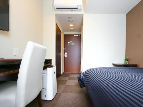 Кровать или кровати в номере HOTEL LiVEMAX Kayabacho
