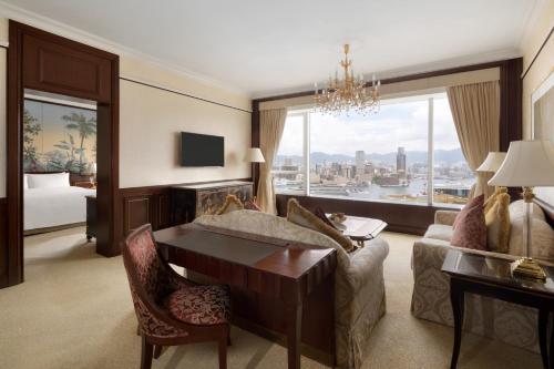 a living room with a couch and a table at Island Shangri-La, Hong Kong in Hong Kong