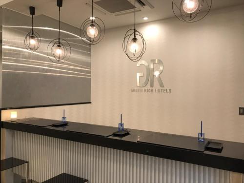 a conference room with lights hanging from a wall at Green Rich Hotel & Capsule Naha - Artificial hot spring Futamata Yunohana in Naha