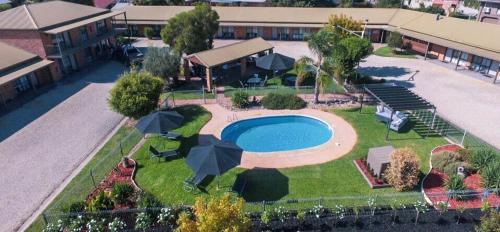 an overhead view of a swimming pool with umbrellas at Statesman Motor Inn in Corowa