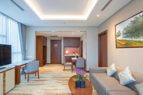 a living room with a couch and a table at Wyndham Garden Hanoi in Hanoi