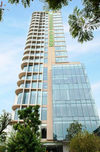 a tall building with a sign on the side of it at Wyndham Garden Hanoi in Hanoi