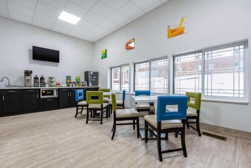 a dining room with chairs and a table in a room at Quality Inn in Coraopolis