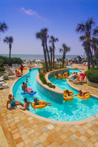 a group of people in a pool at a resort at Coral Beach Resort in Myrtle Beach