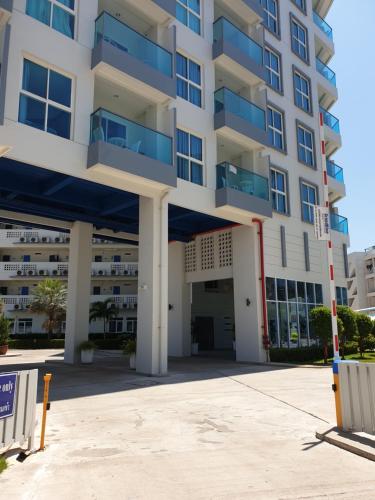 an empty parking lot in front of a building at Grandblue condominium Room 606 in Mae Pim