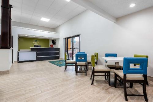 a dining room with a table and chairs at Quality Inn in Coraopolis