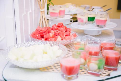 a buffet with several dishes of fruit and drinks at The Capital Residence Suites in Bandar Seri Begawan