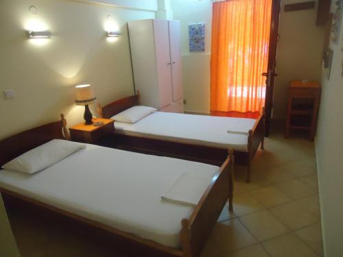 Ένα ή περισσότερα κρεβάτια σε δωμάτιο στο Meltemi Apartments