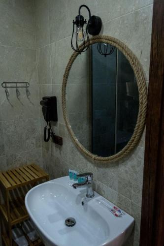 a bathroom with a sink and a mirror at Golden Fleece in Mtskheta