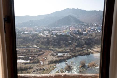 a view of a city from a train window at Golden Fleece in Mtskheta