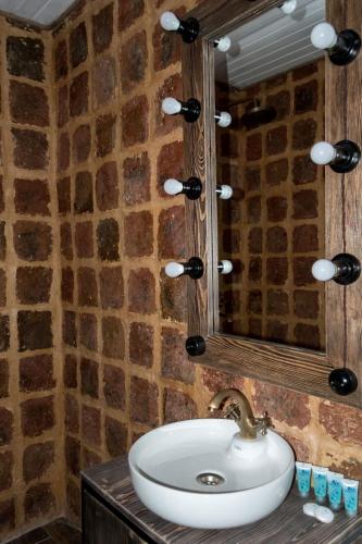 a bathroom with a sink and a mirror at Golden Fleece in Mtskheta
