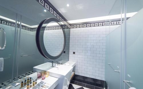 a bathroom with a sink and a mirror at Just Palace Hotel in Taipei