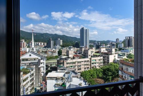 a view of a city from a balcony at Just Palace Hotel in Taipei