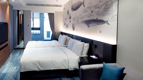 a bedroom with two beds and a wall with a whale mural at Just Palace Hotel in Taipei