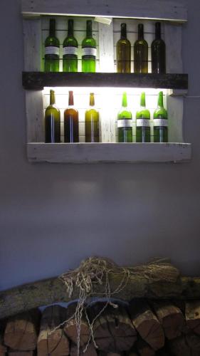 a row of wine bottles on a shelf on a wall at Posada Rural Bistruey in Potes