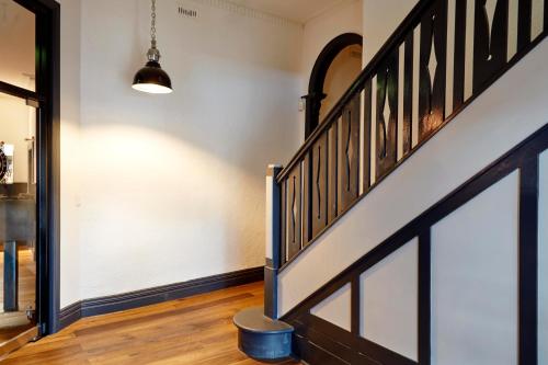 a hallway with a stairway with a stair case at The Royal Hotel, Drouin in Drouin