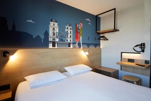 a hotel room with a bed and a painting on the wall at KYRIAD DIRECT Orleans - La Chapelle St Mesmin in La Chapelle-Saint-Mesmin