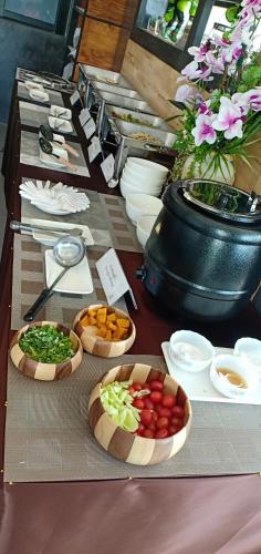 a table with three bowls of food on it at Makan Resort in Kanchanaburi