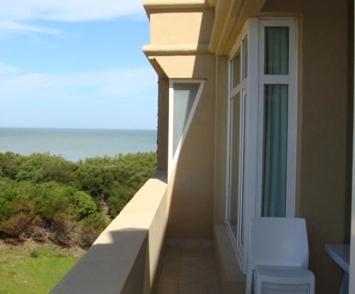 a balcony of a house with a view of the ocean at Cariló Sul Mare in Carilo