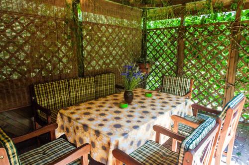 a table and chairs in an outdoor room at Arabela in Rīga