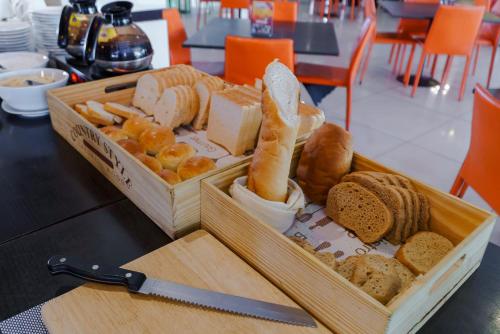 a box of bread and other types of food on a table at Vogue Pattaya Hotel in Pattaya Central