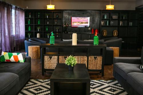 a living room with couches and a table with two soda bottles at Hotel Snö Condes del Pallars in Rialp