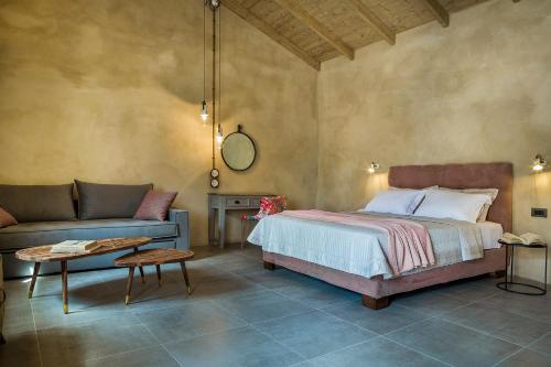 a bedroom with a bed and a couch at Villa Daniela - Saint Nikolas Retreat in Faraklata