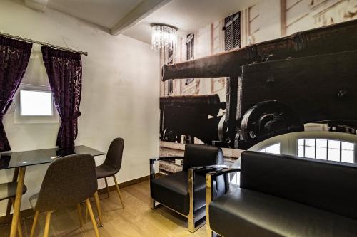 a room with a table and chairs and a piano at Jean de Valette Boutique Living in Valletta