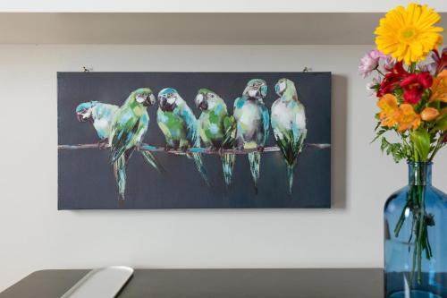 a painting of seven birds sitting on a branch at Rome as you feel - Grotta Pinta apartments in Rome