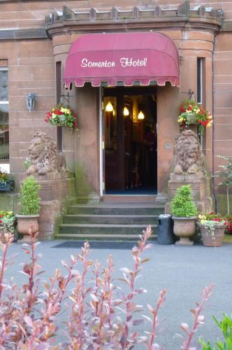 a building with a pink awning on the front at Somerton House Hotel in Lockerbie
