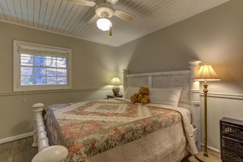 a teddy bear sitting on a bed in a bedroom at Creek Haven in Ellijay