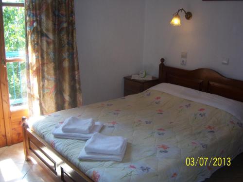 a bedroom with a bed with towels on it at Smile Stella Studios in Skopelos Town