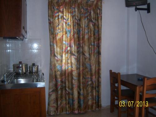 a curtain in a kitchen next to a sink at Smile Stella Studios in Skopelos Town