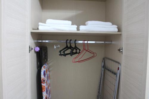 a closet with white towels and a rack with towels at Апарт отель Welcome in Taldykorgan